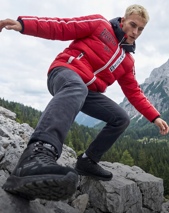 Model im Gebirge trägt Winteroutfit